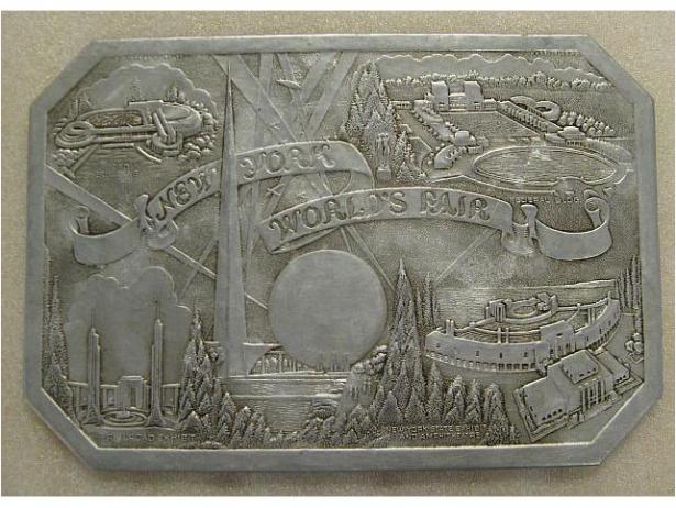 New York World's Fair souvenir hot pad, ca. 1939. Aluminum, cardboard. Gift of Roberta Brandes Gratz, 2008.39.4
